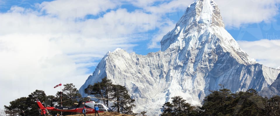 A helicopter landed on a ridge below Ama Dablam in the Everest region